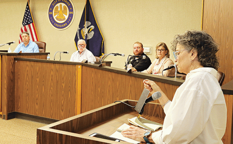 St. Landry Parish School Board member Mary Ellen Donatto speaks at the Eunice city meeting Tuesday about obtaining a Eunice Police officer as a school resource officer for Eunice public schools. Donatto is the District 13 representative to the School Board. The Eunice Board of Aldermen approved an agreement with the School Board for an officer. Shown, seated from left, are Mayor Scott Fontenot, Alderman at-large Marion “Nootsie” Sattler, Alderman Randy Reed and Alderwoman Connie Thibodeaux. (Photo by Harlan