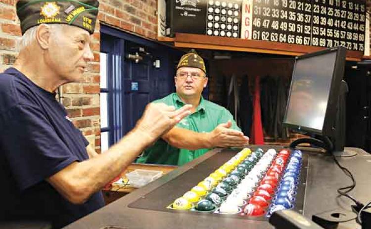 The progressive jackpot at the VFW Post 8971 bingo has reached $10,000. Bingo games are held on Thursdays and Sundays. Explaining the game, from left, are Donald Estillette, post chaplain, and Donnie Fontenot, post commander. (Photo by Harlan Kirgan)