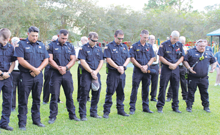 In prayer are first responders during Sunday evening’s 911 ceremony.