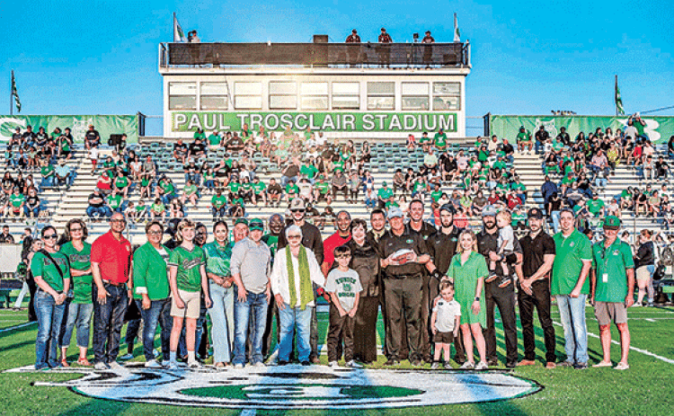 Paul Trosclair, holding a football near the center of photo, was honored at the Sept. 13 football game when the Eunice High School stadium officially was named the Paul Trosclair Stadium. During his career at Eunice High Trosclair has served as athletic director, head football coach and mentor. (Photo by Dwight Jodon)