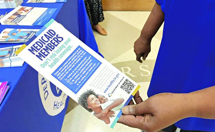 Chenita LeBlanc, a program manager with DePaul Community Health Center, holds a flyer for Louisiana Medicaid members in May. (Michelle Liu/Verite)