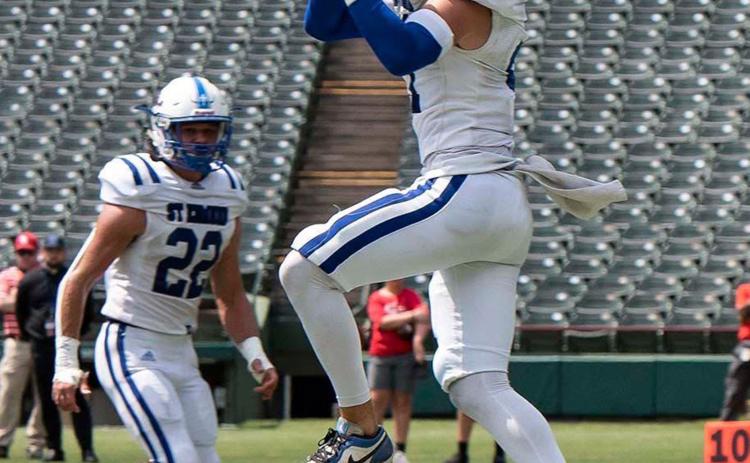 Blue Jay’s safety/kicker Lannie Reed intercepts the ball at the Catholic Bowl in Muenster, Texas. The St. Edmund Blue Jays won 55-6 against Sacred Heart. (Photo by Dwight Jodon)