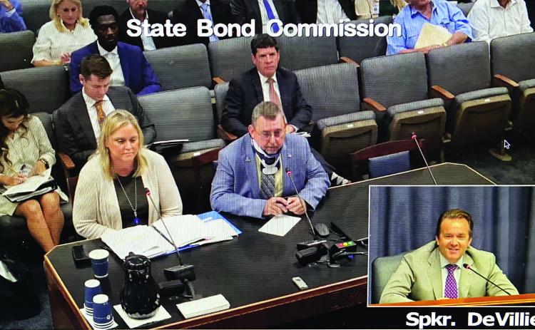 St. Landry Parish President Jessie Bellard, seated at the table, spoke for a $4 million loan at the State Bond Commission meeting on Thursday. Also at the table is Lela Folse, commission staff director. Speaker of the House Phillip DeVillier is in the inset at lower right in this still image captured from a video.