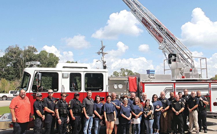 Ardoin’s Funeral Home of Eunice treated first responders to a barbecued pork steak meal on Wednesday in remembrance of the Sept. 11, 2001, response to the terrorist attack on the United States. Some of the Eunice first responders are by a fire truck flying the United States flag at noon. Volunteers served 169 lunches on Wednesday. Ardoin’s has been doing the remembrance since 2002 This year’s event was delayed a week because Hurricane Francine made landfall on Sept. 11. (Photo by Harlan Kirgan)