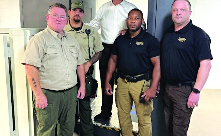 With the full body security scanner at the St. Landry Parish Jail are, from left, Deputy Chief Eddie Thibodeaux, Lt. Brody Istre, Sheriff Bobby Guidroz, Warden Adam Ford and Assistant Warden Nicholas Sheumaker. (Submitted photo)