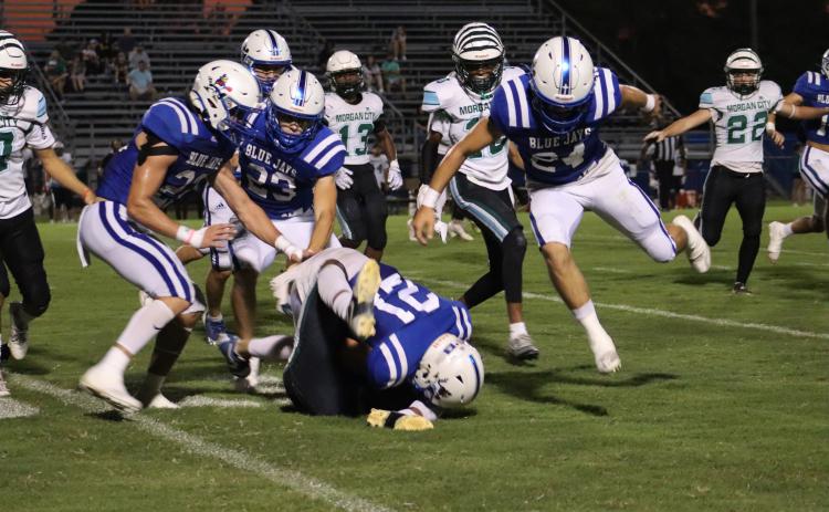 St. Edmund Blue Jay Lannie Reed tackles a Morgan City Tiger player during Friday’s football game played at St. Ed’s home field. (Photo by Amy Myers)