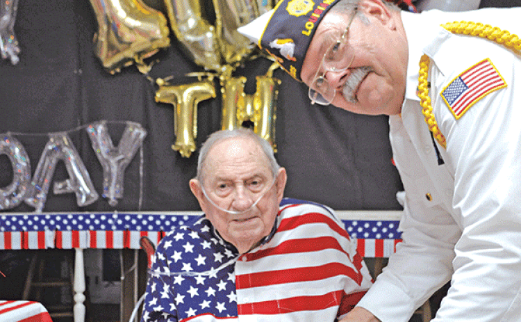 World War II and U.S. Navy Veteran Joe Richard of Church Point is presented with a slice of birthday cake by American Legion Post 225 Commander Dennis Hart during Richard’s 100th birthday party on July 23. Richard, Louisiana’s last known Pearl Harbor survivor, according to the Louisiana Department of Veterans Affairs, passed away Wednesday, just two months after his 100th birthday. (Photo by Claudette Olivier/Church Point News)
