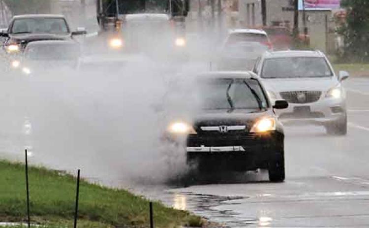 U.S. 190 was a splashy ride on Tuesday and Wednesday as the area received showers. At least 3 inches of rain fell Tuesday. The rainy weather is forecast to continue today. (Photo by Harlan Kirgan)