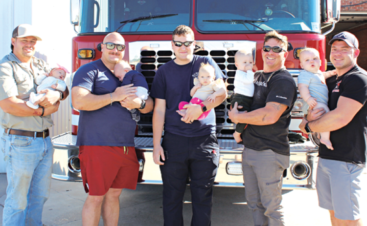 Five Eunice firefighters hold their newborns. The newborns range from 1 month-old to 9 months old. From left, are Firefighter/operator Ben Brown with daughter, Landry Brooks, 1 month old; Firefighter/operator Christian Walker with his 2-month-old son Stephen Russell; Firefighter/operator Blake Smith with his 3 month old daughter, Paisley Grace; Firefighter/operator Ryan Daville with his 8-month-old son, Ellis Scott; and Capt. Garrett Daville with 9-month-old son, Slade Noble. (Photo by Myra Miller)