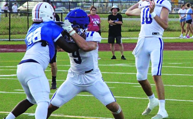 Senior quarterback Nathan Zaunbrecher fires a pass during live action. (Photo by Rhett Manuel)