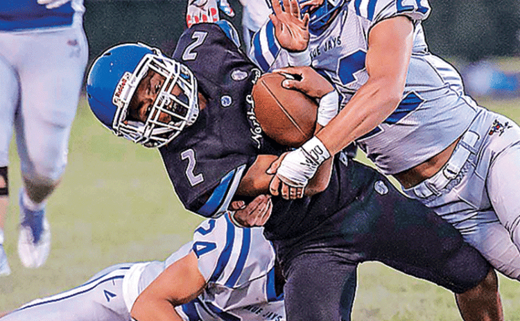 Blue Jay defender brings down a North Central runner. (Photo by Dwight Jodon)