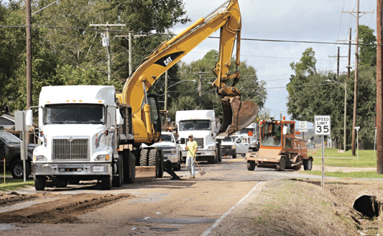 Crews work on Maple Avenue near Champagne’s on Friday morning. (Photo by Harlan Kirgan)