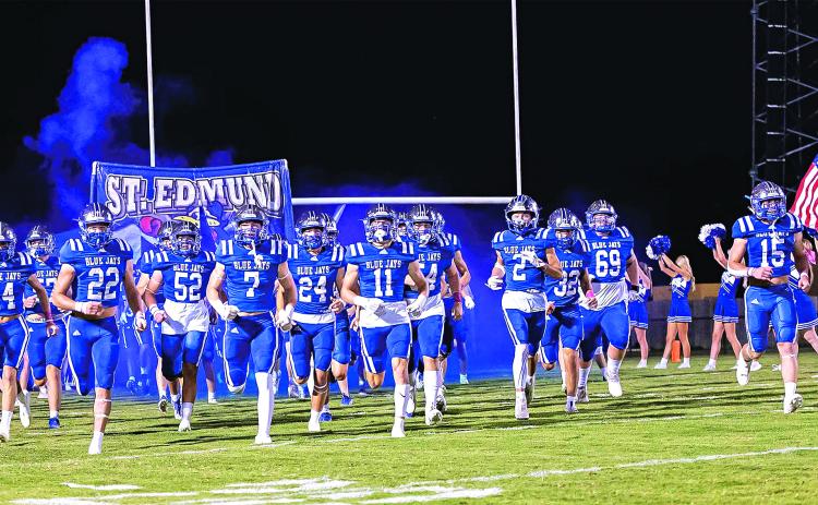 The St. Edmund High School football team takes the field for their homecoming game with Berchmans Academy on Oct. 11. (Photo by Dwight Jodon)