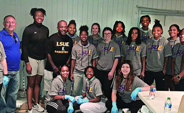 The LSUE Lady  Bengals Basketball team volunteered Wednesday for the ECHC Sausage PoBoy fundraiser held at the VFW Bobcat Hall on Bobcat Drive. Above are the team members, coaches, and Randall Vigee, a volunteer and supporter of the Eunice Community Health Center. (Photo by Glynn Michaud)