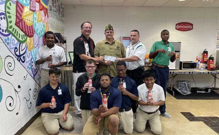 Donnie Fontenot, Commander of VFW Post 8971, in Eunice presented a monetary donation to the Eunice High School Renaissance Cafe Coffee Shop run by the Special Education Department.