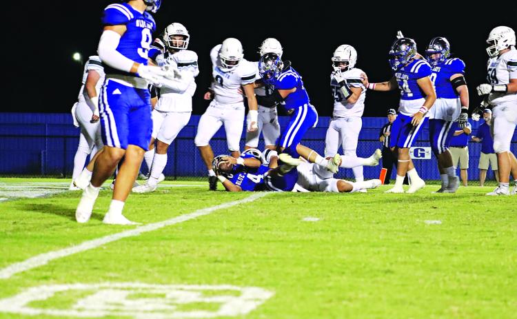 St. Edmund’s Nathan Driggs, No. 4, running back and kicker, makes the first touchdown of the evening during last Friday’s over time win of 52-50 over Catholic-Pointe Coupee. (Photo by Amy Myers)