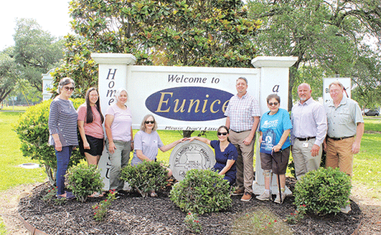 The Welcome to Eunice entrance sign on U.S. 190 east received a refresh by members of the Bulb & Blossom Garden Club. Volunteers re-worked the flowering bed and planted Petite Knock out roses as their project for Arbor Day. Other flowering plants, trees and greenery include two Magnolia trees, ligustrums, and Indian Hawthorns. From left are Lynn Pavich, Sarah Bollich, Fran Guillory, Martha Guempel, Christie Spekschate, Mayor Scott Fontenot, Donna Baltakis, David Ingram and Randy Miller. Participants not pic