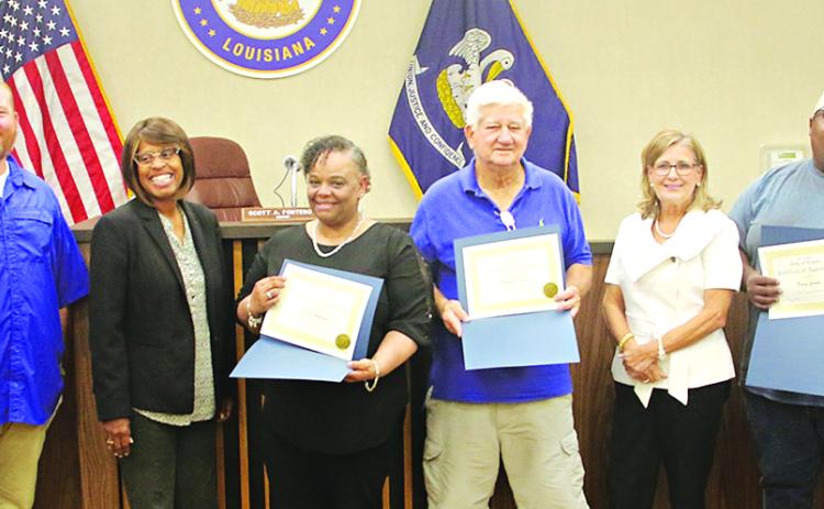 Three volunteers in Eunice were honored during Tuesday’s Mayor and Board of Aldermen meeting. The volunteers are Dorsey Jacobs, Randy Cooper and Debra Guillory. From left, are Stan Feucht, city attorney; Chad Andrepont, alderman; Randall Reed, alderman; Germaine Simpson, alderwoman; Guillory; Cooper; Connie Thibodeaux, alderwoman; Jacobs; Scott Fontenot, mayor; and Marion “Nootsie” Sattler, alderman at-large.