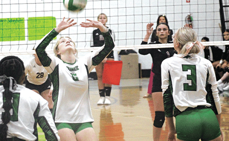Senior Destiny Labbe sets the ball for junior Ava Grace Brown during Wednesday’s match against Jennings at the Tom Dodge Memorial Jamboree. (Photos by Rhett Manuel)