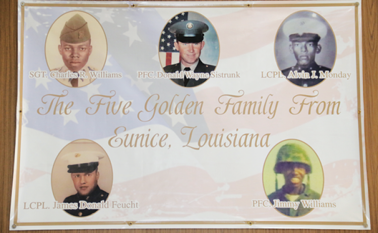 A banner in the lobby of the Eunice Municipal Complex honors five men killed in action during the Vietnam War. Shown, clockwise from bottom left, are Lance Cpl. James Feucht, Sgt. Charles Williams, Pfc. Donald Sistrunk, Lance Cpl. Alvin Monday and Pfc. Jimmy Williams. The banner does not include Pfc. Andrus Duplechain. (Photo by Harlan Kirgan)