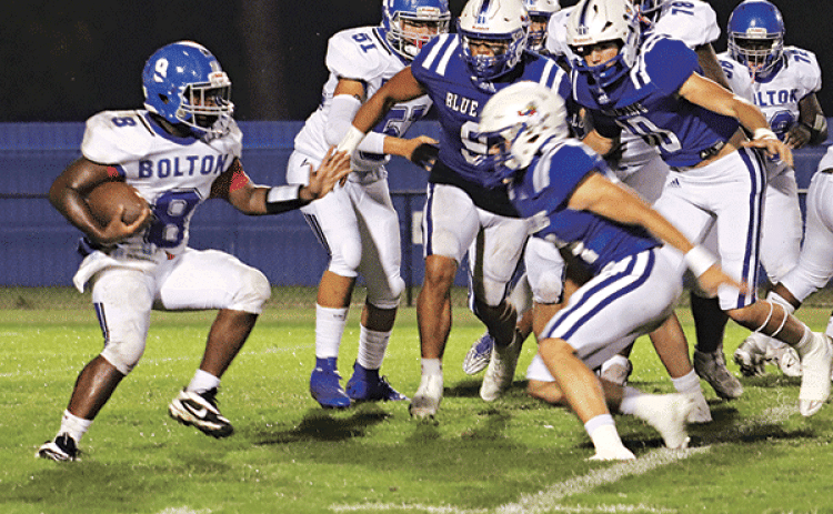 Blue Jay defenders focus on a Bolton runner in a 61-0 win. (Photo by Amy Myers)