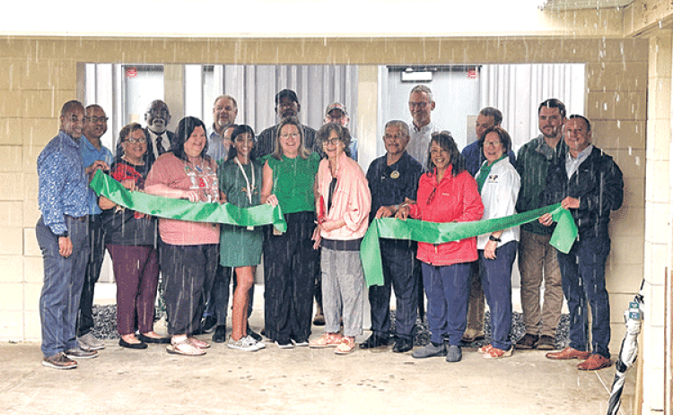 The rain was pouring down during a ribbon-cutting ceremony to celebrate new restrooms at East Elementary in Eunice on Wednesday. Among those present were St. Landry Parish School Superintendent Milton Batiste III, assistant superintendents, several School Board members, Lemoine Company representative, and the instructional leadership team of East Elementary. At the center of the photo, cutting the ribbon is School Board President Mary Ellen Donatto and Principal Gina LaGrange. The new restrooms are funded b