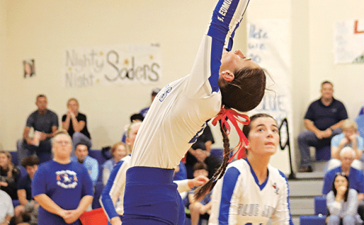 St. Edmund’s Caroline Lavergne, left, leaps for a play as Jillian Devillier keeps an eye on the ball. (Photo by Amy Myers)