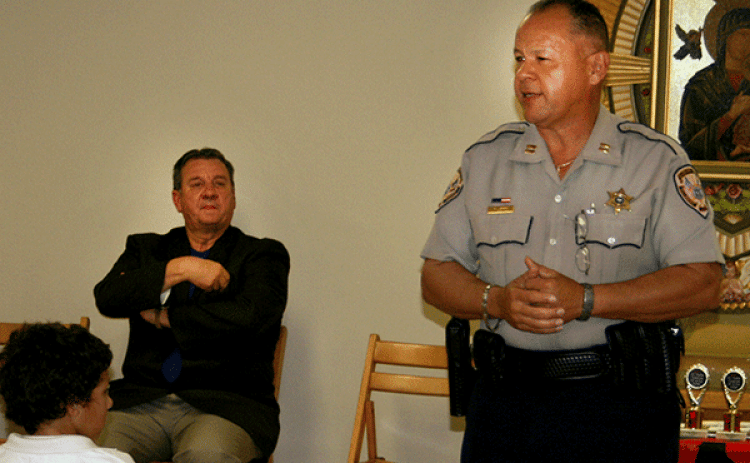 St. Landry Parish Sheriff's DARE officer Theme Ledee, right, is shown during a program at St. Edmund Elementary School in 2009. At left, seated, is Sheriff Bobby Guidroz. (File photo)