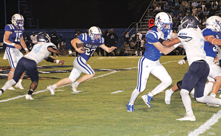In a familiar sight, St. Edmund running back Henry Summerlin carries the ball for yardage this time against Westminster Christian on Thursday. (Photo by Rhett Manuel)