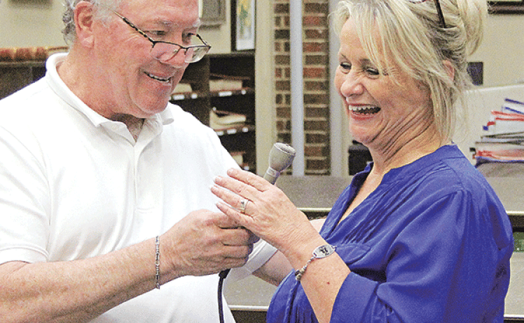 Evangeline Parish Clerk of Court Randy Deshotel, left, hands the microphone to Mamou Mayor-Elect Leisa Deshotel during a live broadcast on KVPI on election night. (Ville Platte Gazette photo by Tony Marks)