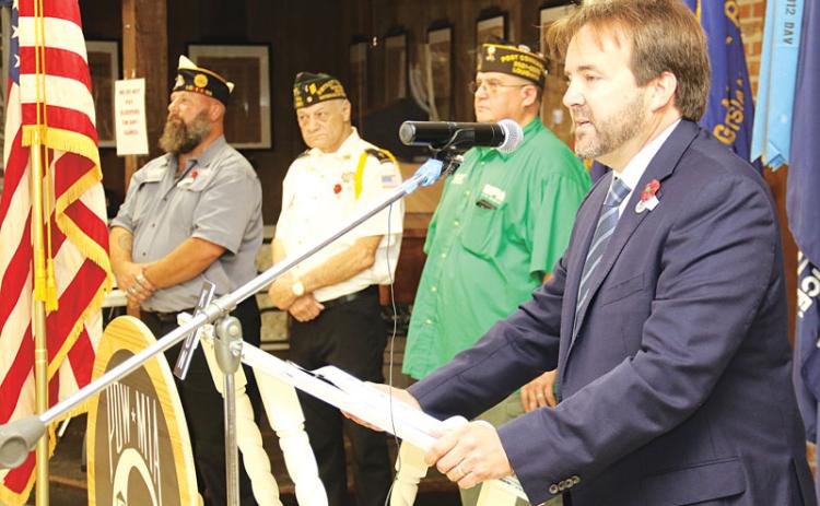 State Rep. Phillip DeVillier, right, speaks at the Eunice VFW Veterans Day celebration on Thursday. Also shown, from left, are David Crader, American Legion Post commander, Donald Estilette, VFW Post chaplain; and Donnie Fontenot, VFW Post commander. More photos on Page 16. (Photo by Harlan Kirgan)