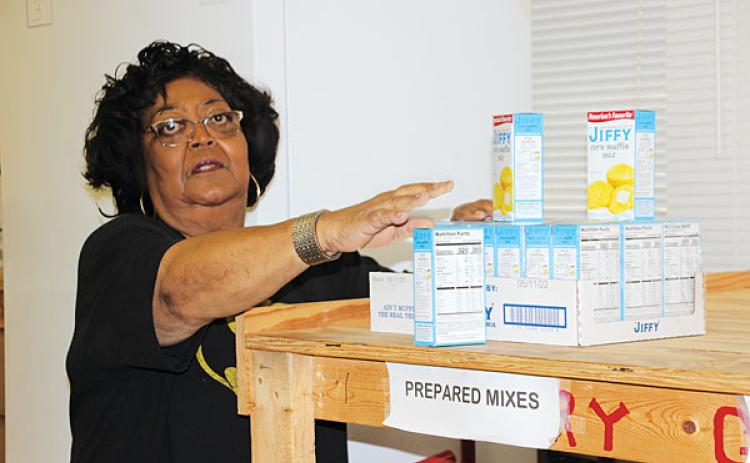 Mary Ann Guillory, director at Eunice Food Bank, is a busy bee trying to stock the food shelves at the food bank. Guillory is preparing for the upcoming annual Eunice Food Bank Drive on  Dec. 7. (Photo by Myra Miller)