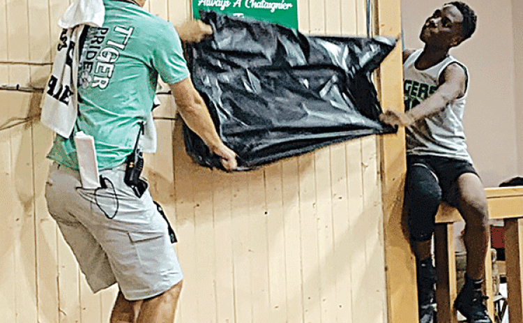 Chataignier Elementary basketball coach Duncan Johnston, left, and Zion Thomas unveil Ty Ardoin’s retired number 55 jersey. (Ville Platte Gazette photo by Rhett Manuel)