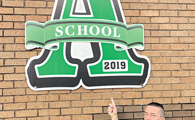 Eunice High School Principal Mitch Fontenot is with a giant A at the school marking its 2019 ranking as an A school in the performance scores. Eunice High scored its fourth A in a row in the annual scores released on Wednesday. (Submitted photo)