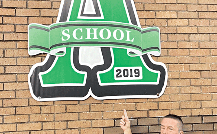 Eunice High School Principal Mitch Fontenot is with a giant A at the school marking its 2019 ranking as an A school in the performance scores. Eunice High scored its fourth A in a row in the annual scores released on Wednesday. (Submitted photo)