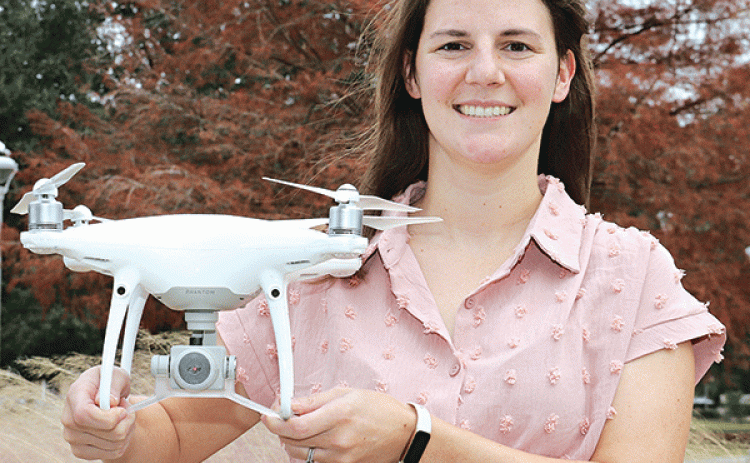 Caitlin deNux holds a drone on the LSUE campus on Tuesday. (Photo by Harlan Kirgan)