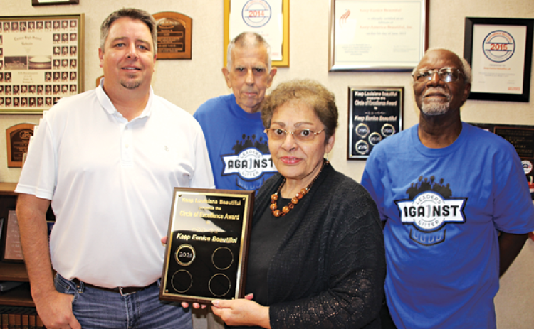 The City of Eunice received the Keep Louisiana Beautiful Circle of Excellence award. The plaque of recognition was presented to Mayor Scott Fontenot by Donna Baltakis, director of Keep Eunice Beautiful. From left, are Fontenot, David Simpson, Baltakis, and Mark Dupre. Simpson and Dupre are on the board of directors of KEB. Keep Louisiana Beautiful also awarded the city six wall mount cigarette ash receptacles. (Photo by Myra Miller)