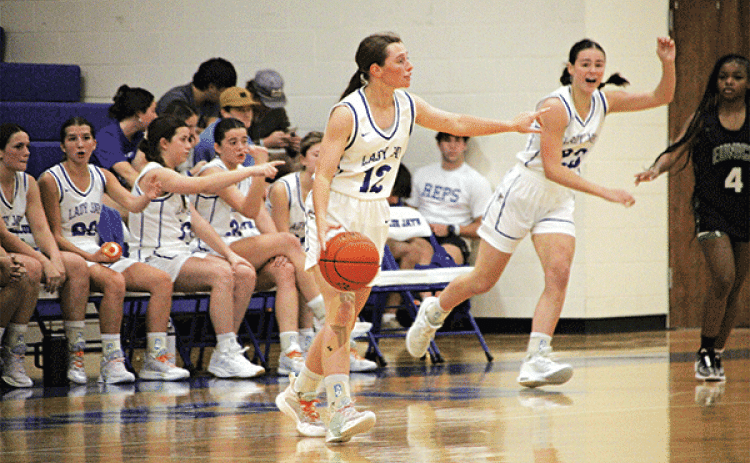 St. Edmund’s Caroline Lavergne sets up a play in the game with Eunice High on Tuesday. In the background is Lady Jay Aubrie LeJeune and Lady Cat Simone Lewis. (Photo by Rhett Manuel)