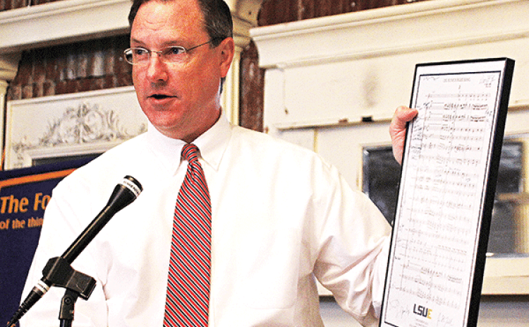 Dwight Jodon holds up the sheet music for the LSU Eunice Fight Song at the Eunice Rotary Club meeting on Nov. 23. (Photo by Tom Dodge)