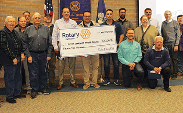 The Eunice Rotary Club presented a $2,200 check to Glyn Michaud, pharmacist at the Eunice Community Health Center, to help defer the cost of the replacement of the front glass doors of the center that were vandalized. From left, are Donnie Richard, John Fontenot, Jerome Fontenot, David Clause, Bob Soileau, David Reed, Kip Bertrand, Michaud, Coby Clavier, Jacob Bergeron, the Rev. Andrew Bates, Shirley Vige, Pat Dossman, John Hamlin, Don Mayeux, Ellis Daigle and Randall Vigee. (Photo by Myra Miller)