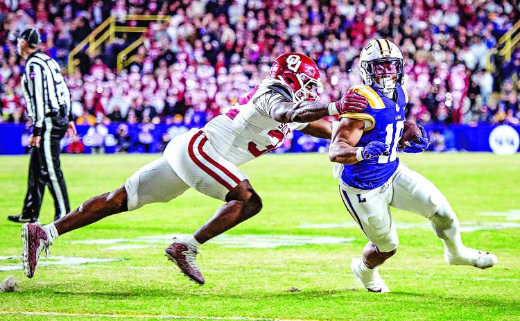 LSU’s Josh Williams tries to escape an Oklahoma defender. (Photo by Dwight Jodon)