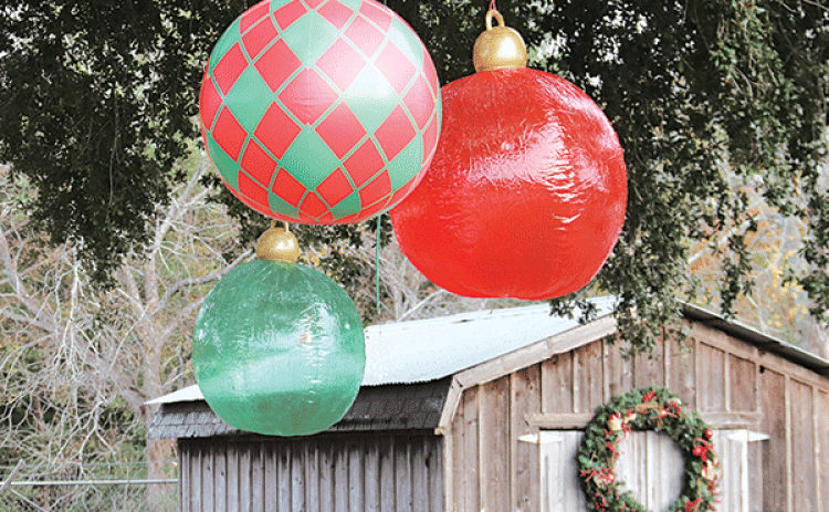 Ornaments hang from an oak tree next to the Community Garden in preparation for the Eunice Community Garden Christmas Festival that starts at 5 p.m. today. The garden is located at 2101 W. Ash St.