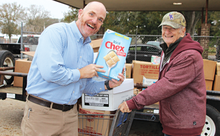 Rev. Brent Shoalmire and Allie Fontenot, were among the many volunteers at the annual Eunice Food Bank Food Drive held Tuesday. About 5.5 tons of food was collected. (Photo by Myra Miller)