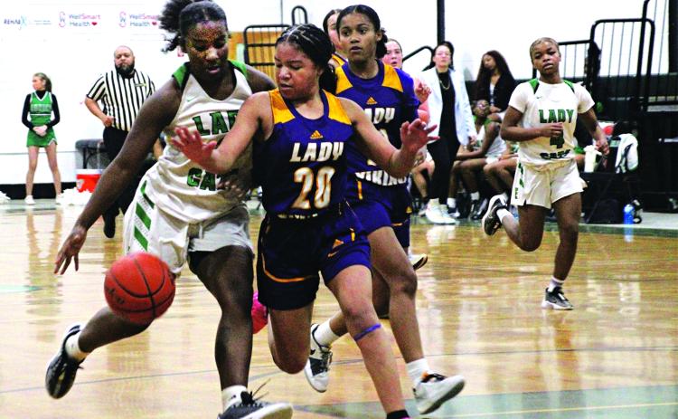 Sophomore guard Cayli Lemelle dribbles past a defender in Tuesday’s win over Opelousas Catholic. She was crucial down the stretch, finishing with eight points all scored in the second half. (Photos by Rhett Manuel)