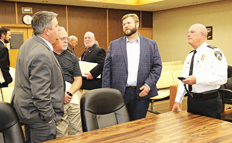 Eunice city officials gather after Tuesday Board of Aldermen meeting. From left, are Chad Andrepont, alderman; Scott Fontenot, mayor; Kyle LeBouef, incoming police chief; Ernest Blanchard, alderman; Marion “Nootsie” Sattler, alderman at-large; Stan Feucht, city attorney; and Randy Fontenot, police chief. (Photo by Harlan Kirgan)