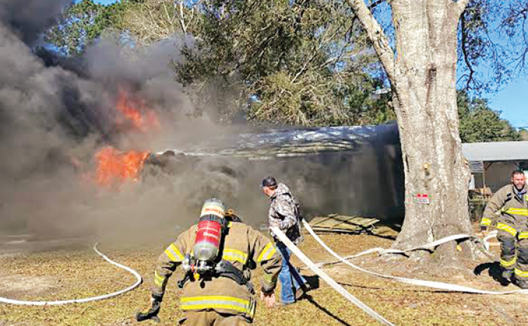 Acadia Parish Fire District 4 firefighters race to a house fire at 227 McManus Road on Sunday. The house of La. 13 south of Eunice was destroyed. Turn to Page 2 for the story and an additional photo. (Photo courtesy of Fire Chief Harral Johnson)