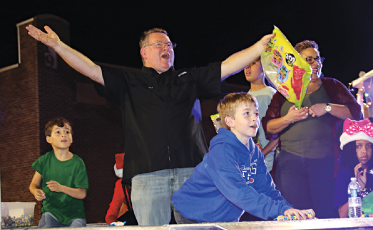 Eddie Thibodeaux appeared to be having fun as he rode on a float from the St. Landry Parish Sheriff’s Office at Thursday’s Christmas Parade of Lights parade in Eunice. Thibodeaux is deputy chief with the Sheriff’s Office. (Photo by Harlan Kirgan)