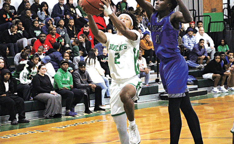 Lady Cats guard Akeviona Monday dribbles past a North Central defender in last Friday’s loss to the Lady Hurricanes.(Photo by Rhett Manuel)