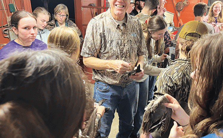 Mark Shirley, a coastal specialist with the LSU AgCenter and Louisiana Sea Grant, smiles while showing wings of various duck species to 4-H members participating in an Advanced Marsh Maneuvers camp in December. Photo by Hilton Waits/LSU AgCenter 