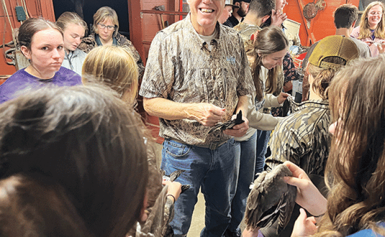 Mark Shirley, a coastal specialist with the LSU AgCenter and Louisiana Sea Grant, smiles while showing wings of various duck species to 4-H members participating in an Advanced Marsh Maneuvers camp in December. Photo by Hilton Waits/LSU AgCenter